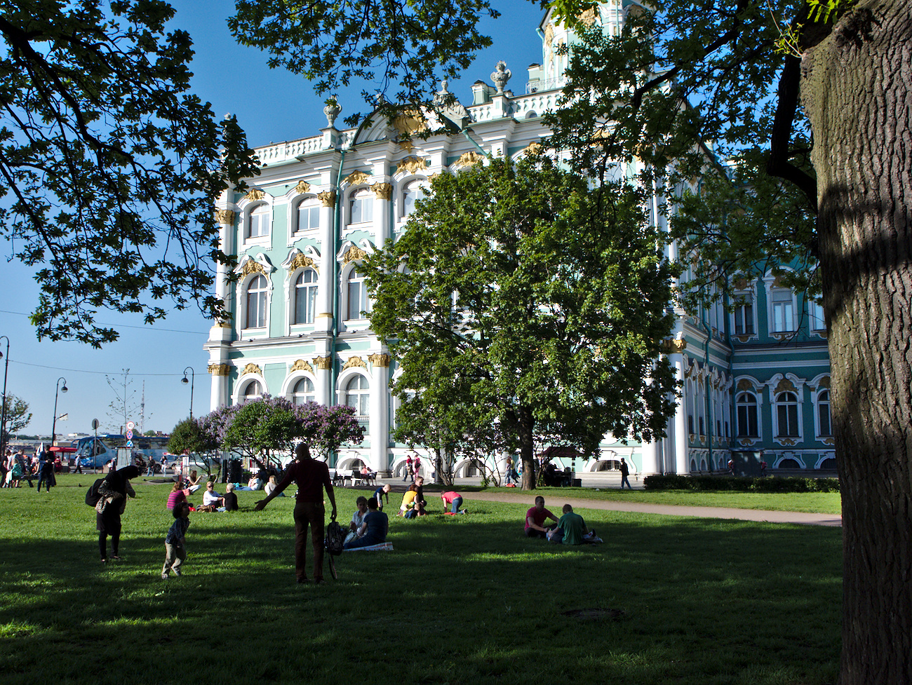 People enjoying the weather next to the Eremitage museum, St. Petersburg, Russia.