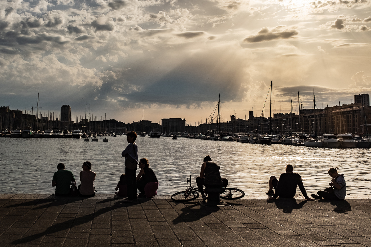 People enjoying the evening at the port of Marseille, France.