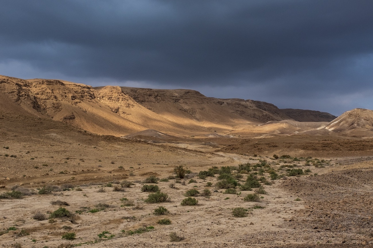 Sun rays are cast through the clouds near Massada, Negev desert, Israel.